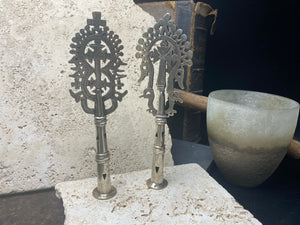 Two small Ethiopian processional crosses, hand cast by the lost wax method. Made from white metal and designed to be displayed and paraded in religious processions on top of wooden staffs, these are used vintage pieces dating to the 1970's, and are from the Lalibela region of northern Ethiopia. Height approximately 19.5 cm