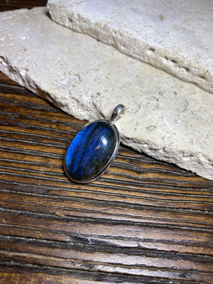 Stunning mid size oval labradorite pendant set in sterling silver with a generous bail to take a large chain or cord. A high set stone with excellent blue colour and fire.