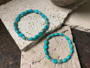 Blue stone bracelet with sterling silver bead detailing. Elasticised stringing for a seamless look.