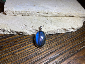 Stunning mid size oval labradorite pendant set in sterling silver with a generous bail to take a large chain or cord. A high set stone with excellent blue colour and fire.
