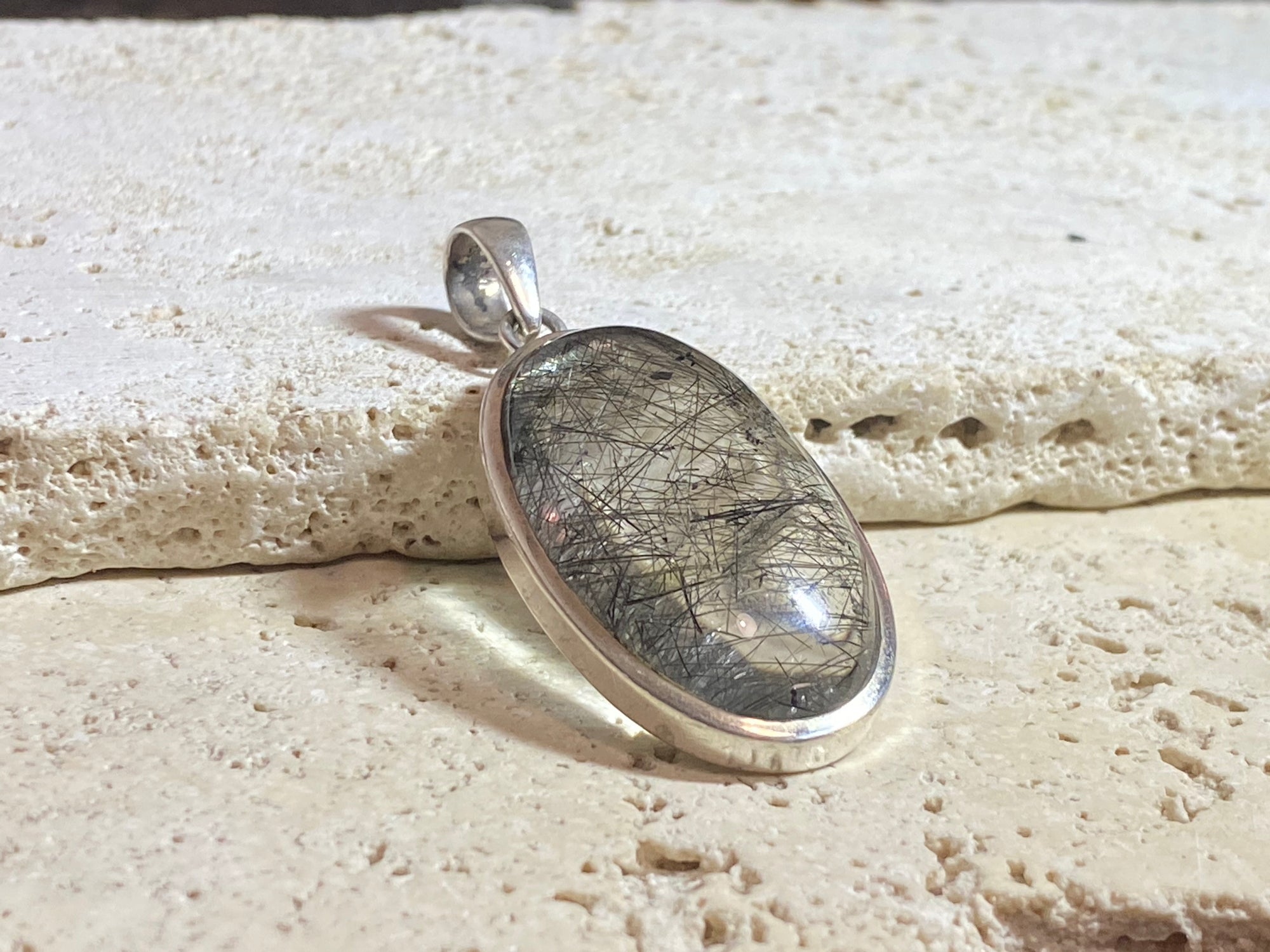 Large natural, tourmalated quartz stone pendant finished with a generous sterling silver mount and bail to emphasise its natural beauty. This is a stunning pendant that is a little out of the ordinary.
