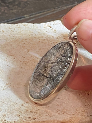 Large natural, tourmalated quartz stone pendant finished with a generous sterling silver mount and bail to emphasise its natural beauty. This is a stunning pendant that is a little out of the ordinary.