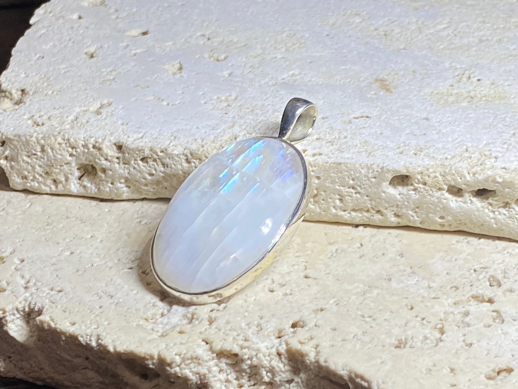 Large oval rainbow moonstone pendant set in sterling silver with a generous bail to take a large chain or cord. A beautiful stone with light blue, green and orange colour. 