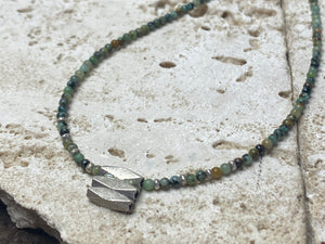 Very fine stone women or mens necklace made from tiny Ethiopian opal beads, highlighted with Karen silver "eye beads" and tribal pendant. The effect is simple, understated and stunning. Finished with sterling silver findings and clasp. A unisex necklace. Length 46.5 cm (18.35")