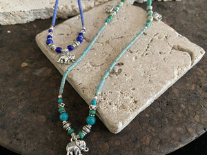 Beaded stone elephant necklace in either turquoise or lapis blue, each featuring three small elephant charms. This beautiful stone necklace is indistinguishable from much more expensive sterling silver and natural turquoise or lapis necklaces. This is unisex jewellery that can be worn either as a bracelet or as a necklace