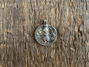 Antique silver amulets representing the Hindu god Kali, in her protective form, and dating from the early 19th - early 20th century. Measurements: all vary between 1.5 and 2.2 cm in width