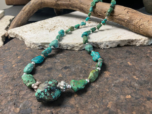 A unique necklace crafted from graduated antique Tibetan turquoise and vintage silver beads, highlighted with sterling silver spacer beads. These beautiful natural stones range in colour from mid to dark blue-green and are all antiques in their own right. The best turquoise we've ever found. This long tribal necklace can be worn by either men or woman. Total length 62.7 cm