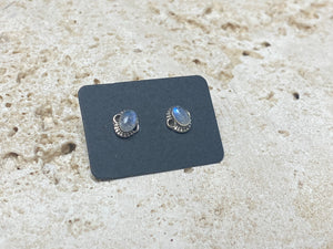 Simple and elegant, these small rainbow moonstone earring studs are hand made from sterling silver and set with natural rainbow moonstone cabochon stones