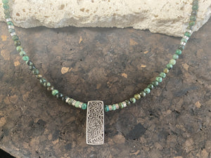 Contemporary necklace of round natural African turquoise, highlighted with sterling silver beads, a vintage Indian filigree silver pendant and sterling silver findings and clasp. Length 43.5 cm (17.25”), pendant 2.2 cm (1")