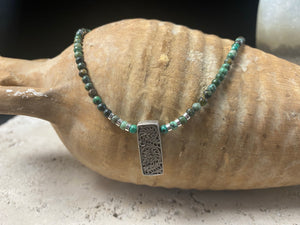 Contemporary necklace of round natural African turquoise, highlighted with sterling silver beads, a vintage Indian filigree silver pendant and sterling silver findings and clasp. Length 43.5 cm (17.25”), pendant 2.2 cm (1")