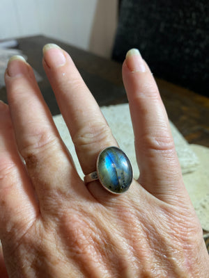 Round oval labradorite ring set in sterling silver. A high quality stone with green, blue and orange fire.  Size 7.5