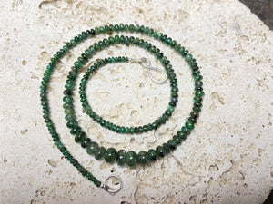 Stunning natural emerald necklace of perfectly drilled and graduated cabochon cut African emeralds finished with a sterling silver hook clasp. Not dyed or heat treated. Premium stringing on jeweller's monofilament. Length 44 cm, 52.6 Ct.
