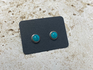 Small natural turquoise earring studs are hand made from sterling silver and set with turquoise cabochons. A unisex earring