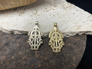 Front view of our two Cross on Staff Style Ethiopian Cross pendants, the left a silver alloy, the right a brass alloy. Lost wax casting, hand made tribal African jewellery, boho, Christian, bohemian - 5.4 cm (2.19")