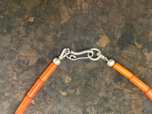 Orange-red coral necklace with sterling silver filigree pendant. Finished with l silver hook clasp. Length 45 cm