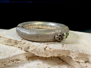 Women's antique tribal anklet, hollow construction, made in a round rigid style with a hinged opening. Very high grade silver, with repeating decoration around all sides and a decorative hinge. From Rajasthan, India. Late 19th century or older.