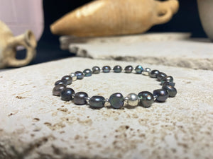 Grey black freshwater pearl bracelet with sterling silver bead detailing. Elasticised stringing for a seamless look. Length 19 cm