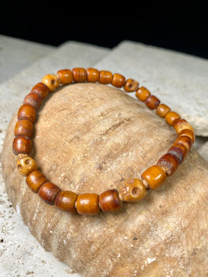 Carved vintage yak bone bead bracelet features carved skull beads and tiny sandalwood spacer beads. Unique and beautiful. Stretchy cord, wear alone or stacked with other bracelets for a classic boho look. Two sizes, 20 cm and 18 cm. Unisex jewellery for men or women.