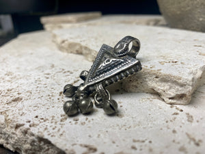 High grade silver pendant, late 19th century, Turkmenistan. It features bands of applied decorative work and a central hammered tree of life design. The pattern is repeated on both sides of the pendant. Length 6 cm