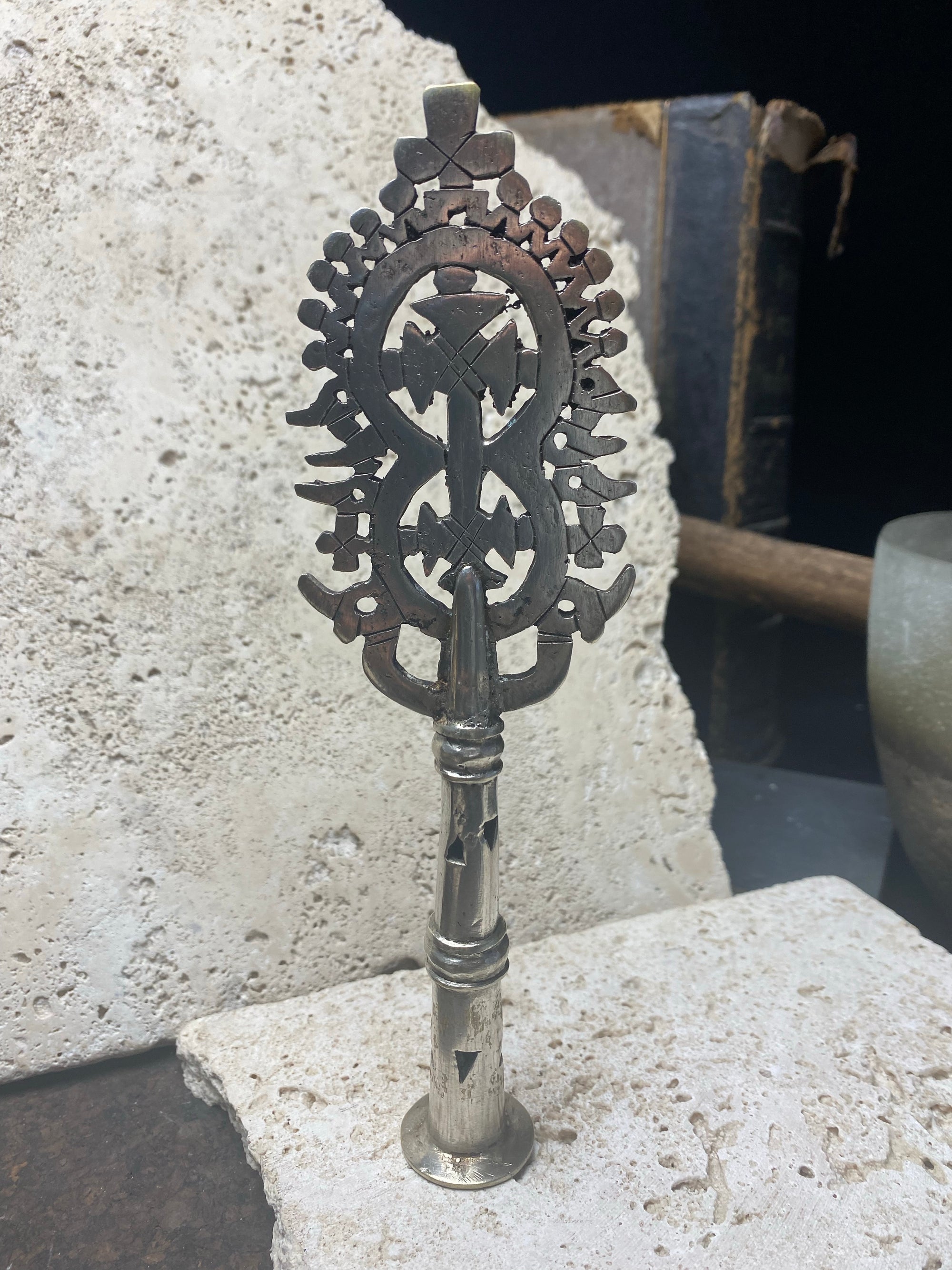 Two small Ethiopian processional crosses, hand cast by the lost wax method. Made from white metal and designed to be displayed and paraded in religious processions on top of wooden staffs, these are used vintage pieces dating to the 1970's, and are from the Lalibela region of northern Ethiopia. Height approximately 19.5 cm