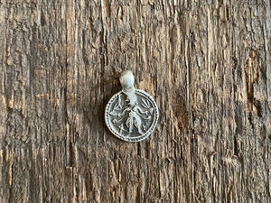 Antique silver amulets representing the Hindu god Kali, in her protective form, and dating from the early 19th - early 20th century. Measurements: all vary between 1.5 and 2.2 cm in width