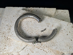 Women's antique tribal anklet, hollow construction, made in a round rigid style with a hinged opening. Very high grade silver, with repeating decoration around all sides and a decorative hinge. From Rajasthan, India. Late 19th century or older.