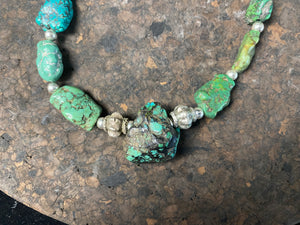 A unique necklace crafted from graduated antique Tibetan turquoise and vintage silver beads, highlighted with sterling silver spacer beads. These beautiful natural stones range in colour from mid to dark blue-green and are all antiques in their own right. The best turquoise we've ever found. This long tribal necklace can be worn by either men or woman. Total length 62.7 cm