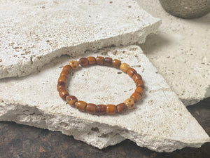 Carved vintage yak bone bead bracelet features carved skull beads and tiny sandalwood spacer beads. Unique and beautiful. Stretchy cord, wear alone or stacked with other bracelets for a classic boho look. Two sizes, 20 cm and 18 cm. Unisex jewellery for men or women.