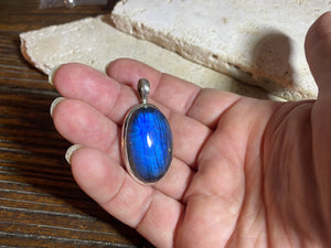 Stunning mid size oval labradorite pendant set in sterling silver with a generous bail to take a large chain or cord. A high set stone with excellent blue colour and fire.