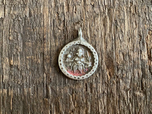 Antique silver amulets representing the Hindu god Kali, in her protective form, and dating from the early 19th - early 20th century. Measurements: all vary between 1.5 and 2.2 cm in width