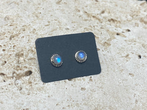 Simple and elegant, these small rainbow moonstone earring studs are hand made from sterling silver and set with natural rainbow moonstone cabochon stones