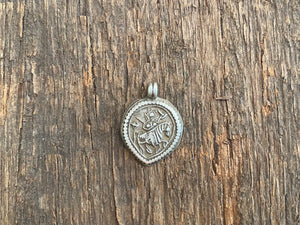 Antique silver amulets that represent Baba Ramdev (Ramdevshi), a legendary Rajput warrior who went about doing deeds of goodness and valour. These small pendants are traditionally worn for protection and good luck and date from the early 19th - early 20th century. Measurements: all vary between 1.5 and 1.7 cm in width