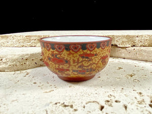 These tiny tea bowls are made from fired clay, glazed on the inside and beautifully decorated on the outside with a pattern of cloud spandrels. Stamped with the makers mark on the base. From Nepal.  As well as tea bowls, these make beautiful miniature offering bowls and when filled with sand, are perfect for holding incense sticks in the Chinese style.  Measurements: 3 cm height, diameter at top 5 cm