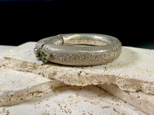 Women's antique tribal anklet, hollow construction, made in a round rigid style with a hinged opening. Very high grade silver, with repeating decoration around all sides and a decorative hinge. From Rajasthan, India. Late 19th century or older.