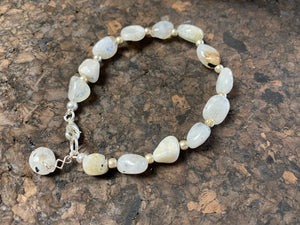 Boho style bracelet made from natural rainbow moonstone stones, finished with sterling silver. A single moonstone drop acts as both a feature to catch the eye and as a counterweight, keeping the bracelet sitting the right way up on the wrist. 18.5 cm length (7.3")