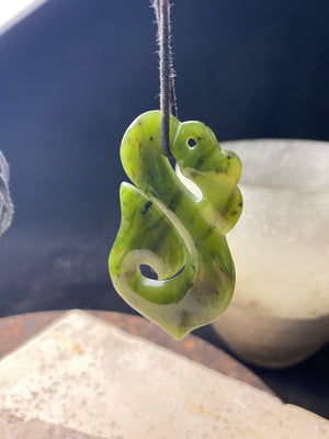 Stunning natural light green veined jade Maori guardian Manaia pendant