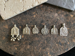 Antique silver amulets represent the Hindu goddess Kansari, goddess of the harvest and of fertility. These small pendants are traditionally worn for good luck, to increase fertility and to bring all good things to you and your home. These pendants date from the early 19th - early 20th century. Measurements: all vary between 1.4 and 1.8 cm in width