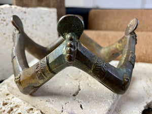 antique upper arm cuff or bracelet, depicting 4 pairs of decorated and bejewelled female arms and hands clasping mirrors. Cast bronze, in excellent condition, showing wear to the inside and underside surfaces