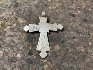 Early 20th century Ethiopian silver cross, most likely cut from a Marie Therese Thaler. Silver, with a simple engraved decoration on each side and light wear at the head of the bail, total height including bail 7.5 cm (3")