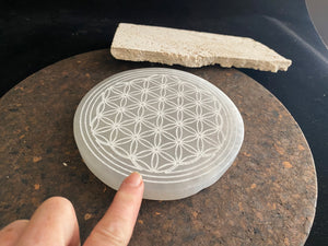 Large, engraved selenite charging plate or stand for the display of crystals and other important objects. Diameter 14.8 cm