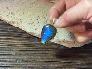 Stunning upside-down teardrop labradorite pendant set in sterling silver with a generous bail to take a large chain or cord. A stunning, high quality stone with excellent blue colour and fire.