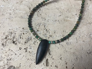 Fine unisex necklace of round natural stone beads, highlighted with Karen hill tribe sterling silver "eye beads" and a long pendant of unpolished onyx. The effect is simple and stunning. Finished with sterling silver findings and hook clasp. Length 42 cm