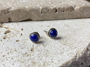 Simple and elegant, these small lapis lazuli earring studs are hand made from sterling silver and set with lapis cabochons
