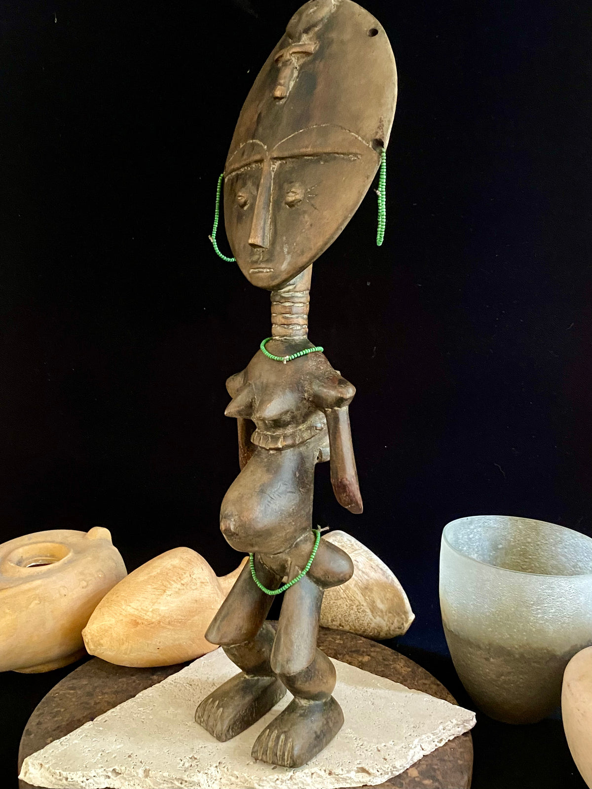 Akuaba or Aquaba Doll, Asante, from Ghana. Mid 20th Century, vintage fertility idol with carved neck rings and beaded decoration and carries a smaller, more traditional akuaba figure on her forehead. She is detailed on the back, wearing a carved baby carrier. Height 45.5 cm