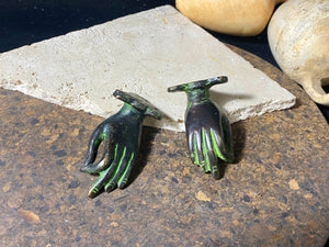 Bronze hands of Buddha that can be oriented up, sideways or downward facing. Hand cast from solid brass with a diamond shaped lotus viswa vajra in the centre of each palm and highlighted with a light green pigment. The hands have three attachment points. These make beautiful door, cupboard or drawer handles, and also work as pegs. Price is for one pair. Measurements: 9 cm (3.4") length