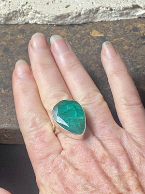 Our large facet cut emerald is set in a simple sterling silver bezel to show off the beauty and size of the stone, which is frankly huge. And it's a beautifully even, deep coloured stone as well. This is a statement ring that can be worn be either men or women.  Measurements:  Emerald 2.5 x 1.7 cm Size 8.5 | 18.75 mm