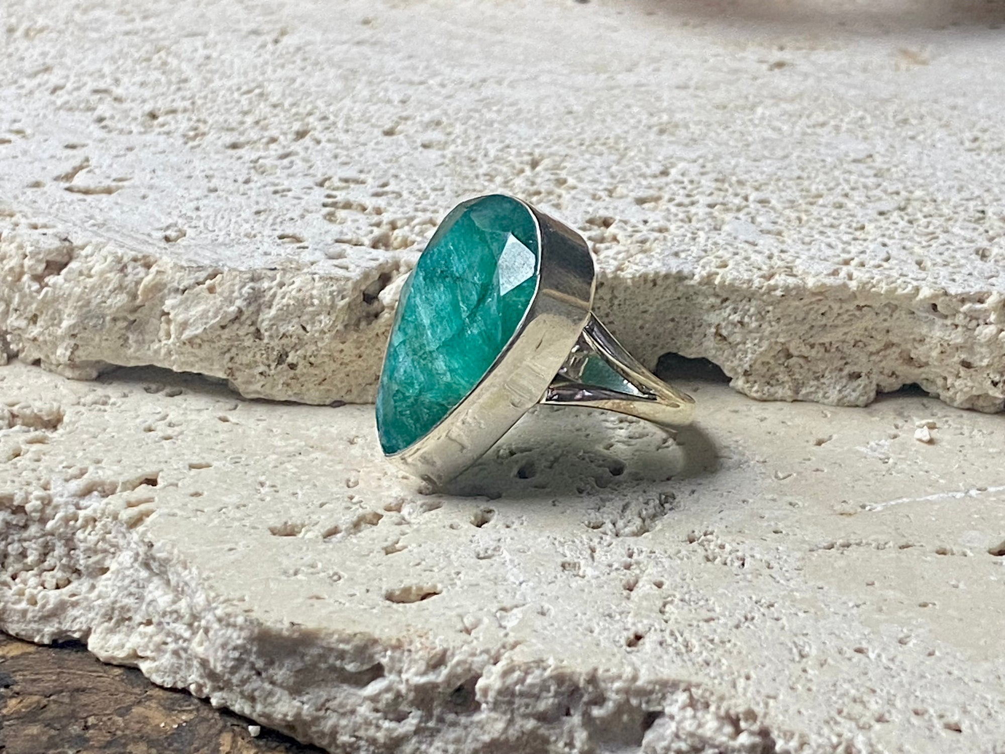 Our large facet cut emerald is set in a simple sterling silver bezel to show off the beauty and size of the stone, which is frankly huge. And it's a beautifully even, deep coloured stone as well. This is a statement ring that can be worn be either men or women.  Measurements:  Emerald 2.5 x 1.7 cm Size 8.5 | 18.75 mm