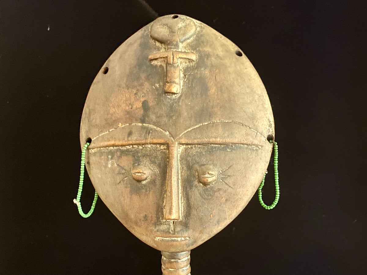 Akuaba or Aquaba Doll, Asante, from Ghana. Mid 20th Century, vintage fertility idol with carved neck rings and beaded decoration and carries a smaller, more traditional akuaba figure on her forehead. She is detailed on the back, wearing a carved baby carrier. Height 45.5 cm