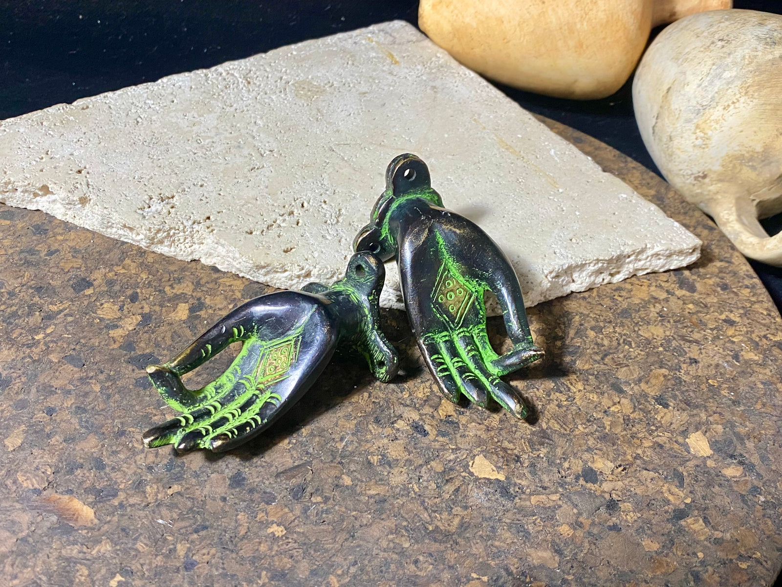 Bronze hands of Buddha that can be oriented up, sideways or downward facing. Hand cast from solid brass with a diamond shaped lotus viswa vajra in the centre of each palm and highlighted with a light green pigment. The hands have three attachment points. These make beautiful door, cupboard or drawer handles, and also work as pegs. Price is for one pair. Measurements: 9 cm (3.4") length