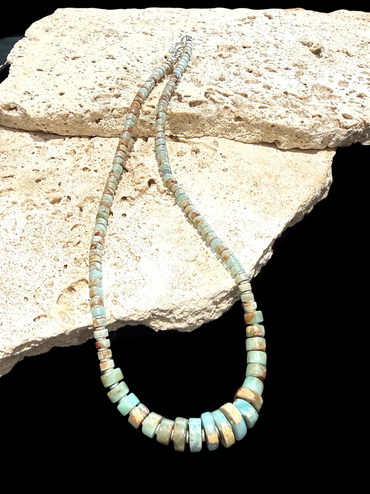 Choker necklace of graduated heshi cut pale blue amzonite, separated by sterling spacers. Sterling silver clasp. 42.5 cm length, beads 3-9 mm diameter